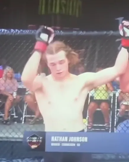 The referee raises Nathan Johnson's hand after his LFS debut, his name on the broadcast lower third