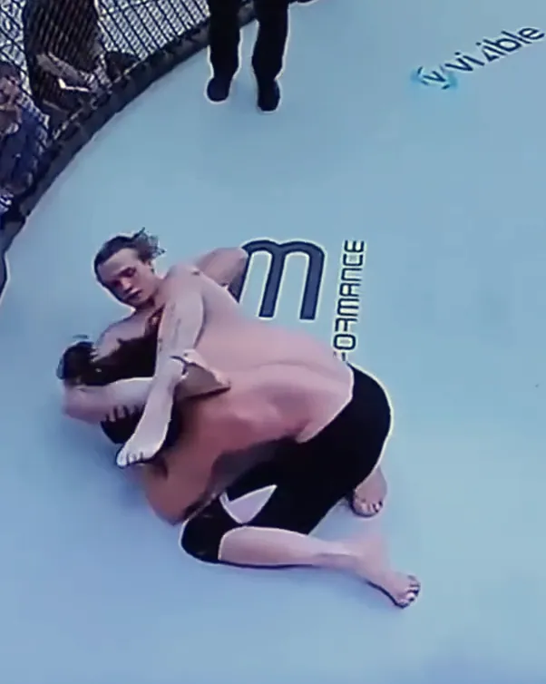 Overhead broadcast view of Nathan Johnson locking a triangle choke at his LFS debut