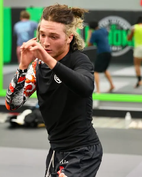 Nathan Johnson with his guard up at the gym, koi-print rashguard