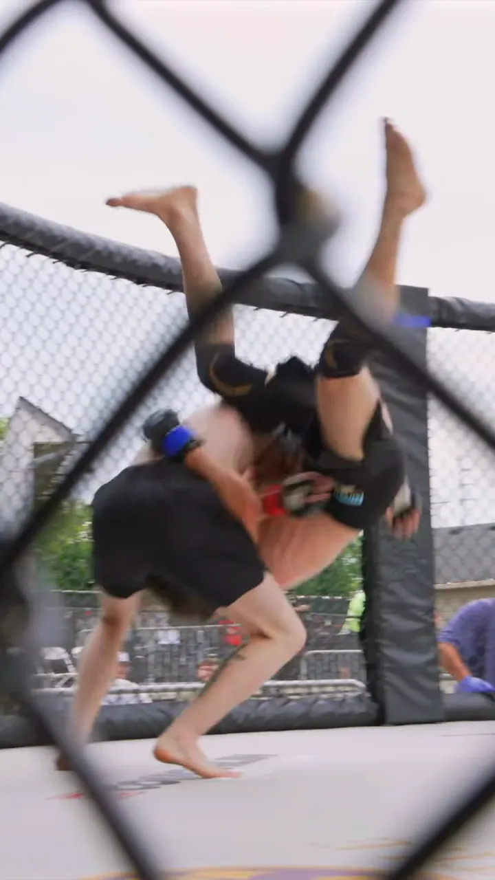 Nathan Johnson lifting his opponent for a slam at the fence, LFS debut