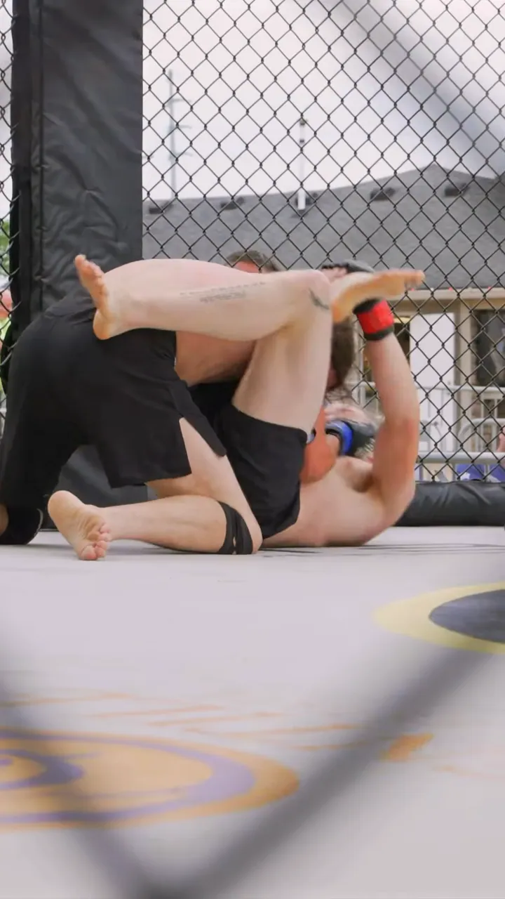 Nathan Johnson on his back, locking the triangle choke at his LFS debut